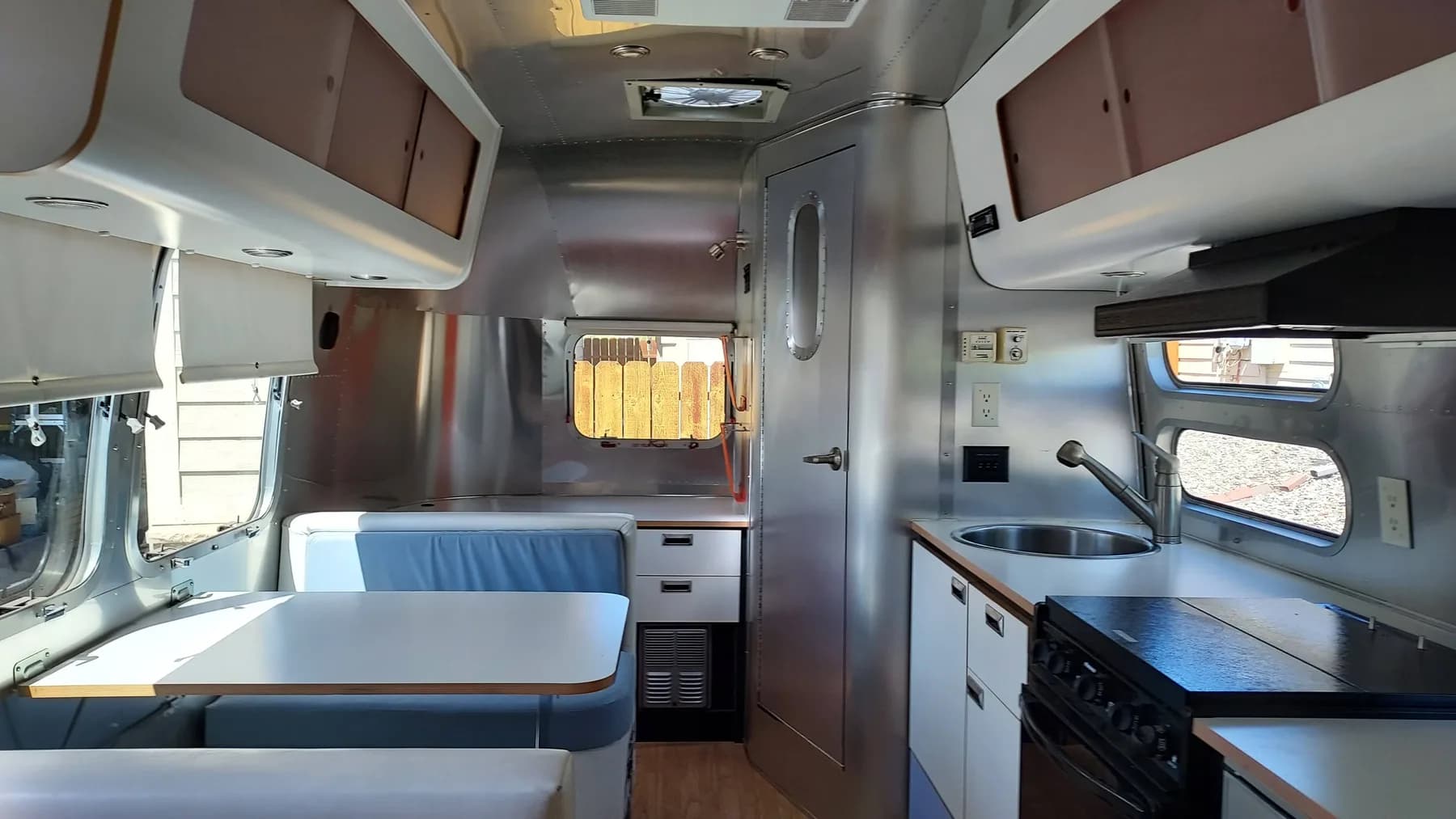 Full Airstream Safari interior showing the dinette, kitchen, and rear workspace